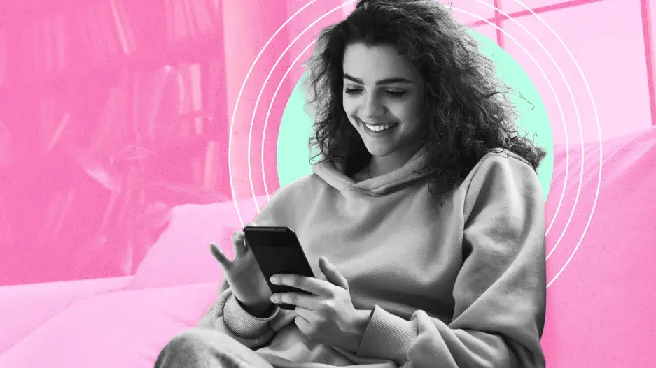 una mujer joven en camiseta mirando su teléfono